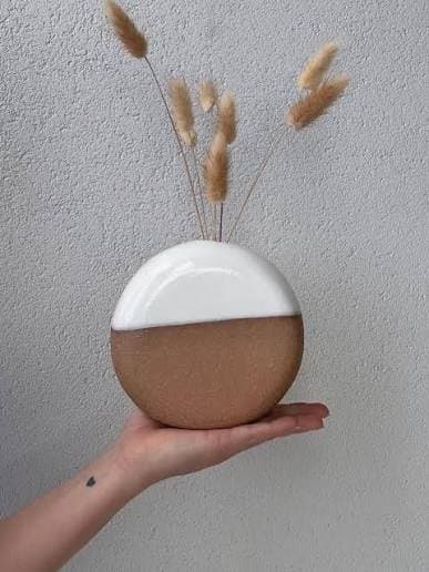 Round vase with dried grass stems